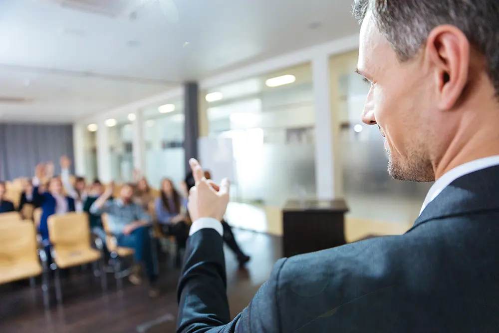 A speaker addressing an audience in the main hall
